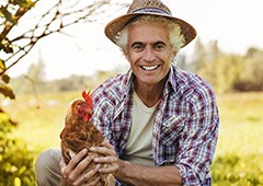 farmer holding a chicken