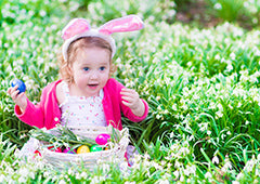 Young girl with basket of easter eggs in backyard