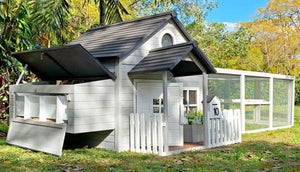 bed and breakfast chicken coop in a garden with blue sky with nesting box open