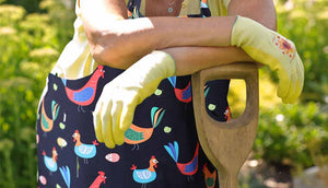 close up of woman wearing chicken apron outdoors